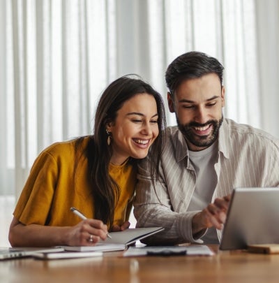 Couple reviewing financial documents together at home