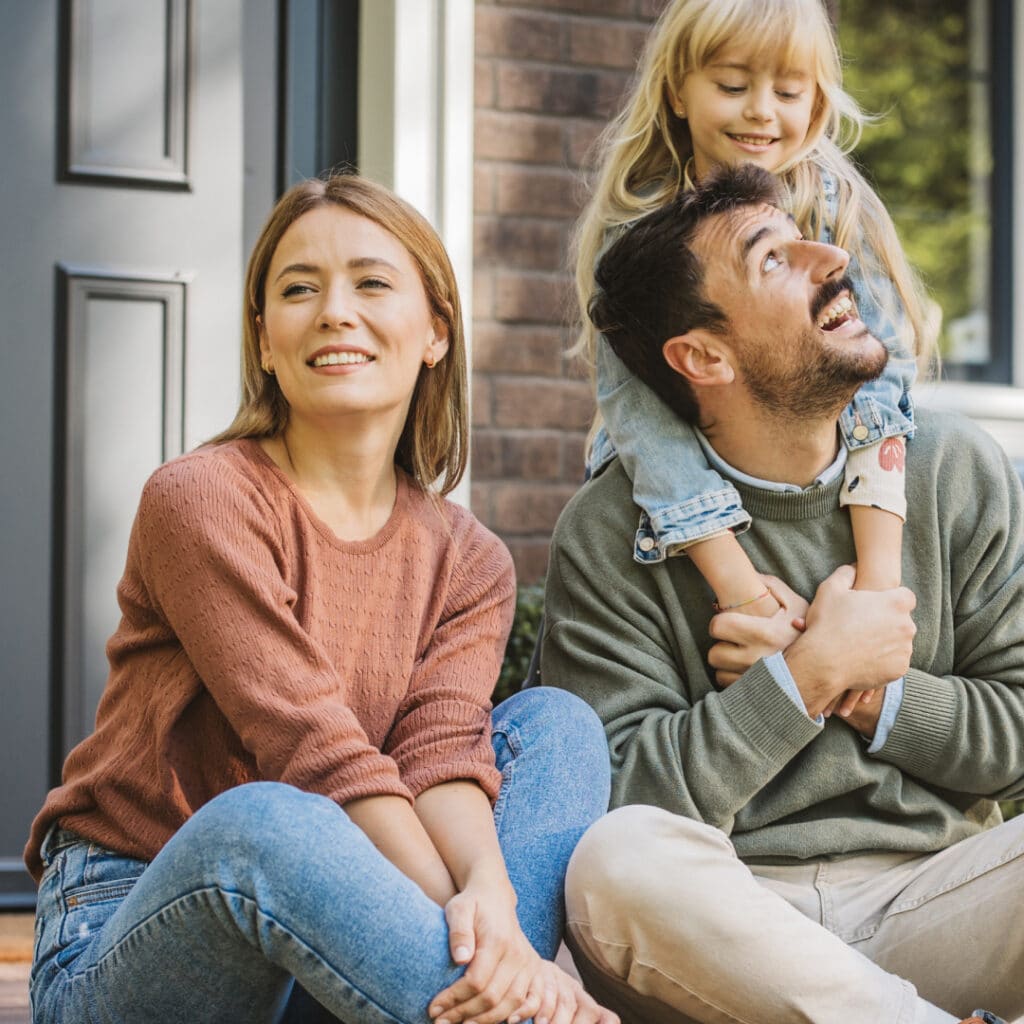 Young family enjoying time together outdoors, representing key life stages when to review and adjust life insurance coverage
