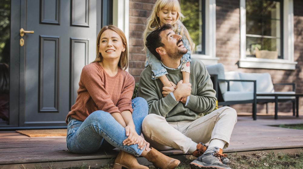 Young family enjoying time together outdoors, representing key life stages when to review and adjust life insurance coverage