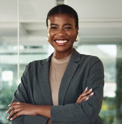 Confident federal professional smiling in an office environment while representing a civilian government career role.