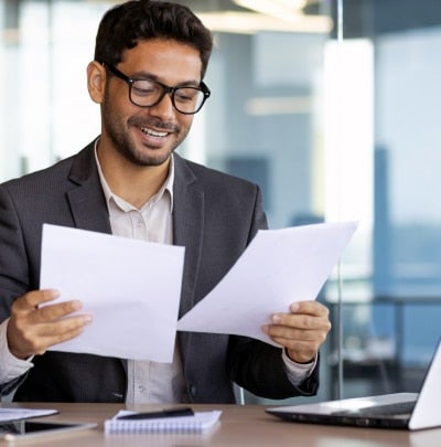 Federal employee reviewing life insurance and financial planning documents.